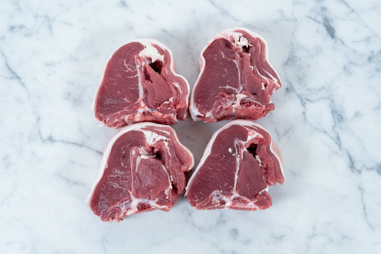 Four raw lamb chops