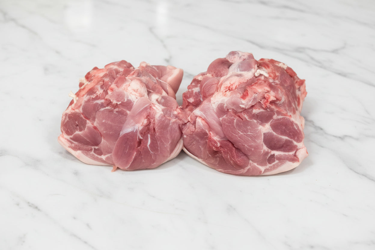 Two raw shoulders of pork