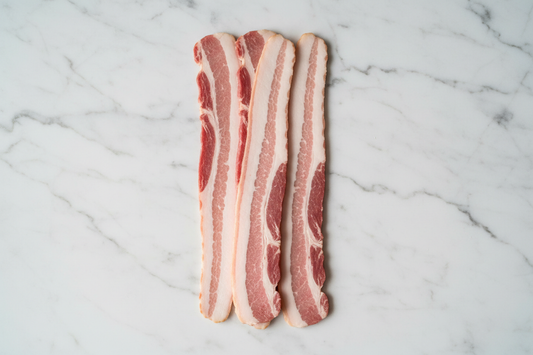 can you create a image of streaky bacon. Place on a white marble background looking down on the product keeping a clean background to be suitable for a meat butchery